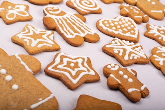 Gingerbread men stars and snowflakes glazed cookies Christmas background