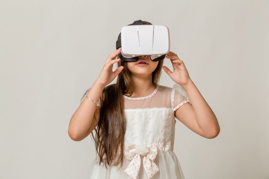 Young girl wearing virtual reality VR goggles