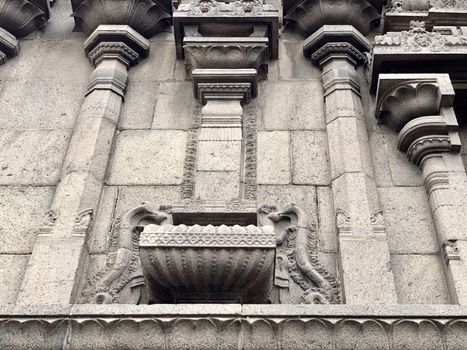 Beautiful carving decoration done in the granite stone at the exterior wall of the ancient temple