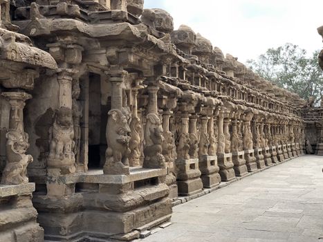 Beautiful view of row of pillars with carvings of sandstone sculpture of Hindu Gods and Lion animals in the ancient temple at Kanchipuram, Tamilnadu