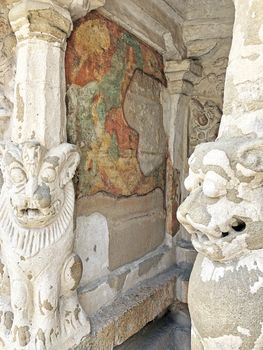 Ancient sandstone sculptures of Lion, Hindu Gods carved in the temple walls at the temple. Old paintings also seen in the walls