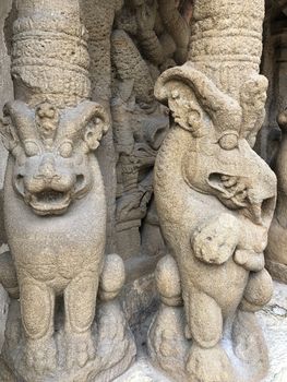 Ancient sandstone sculptures of Lion, Hindu Gods carved in the temple walls at the temple. Old paintings also seen in the walls