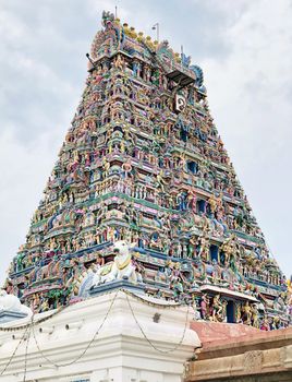 Tower of an ancient temple with beautiful sculptures and statue painted with blue sky background