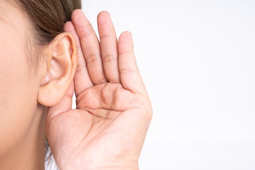 woman hearing loss or hard of hearing and cupping her hand behind her ear isolate on white background, Deaf concept.