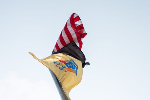 Three Flags Flying in a Grey Sky, One Being a US Flag