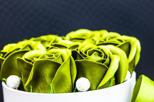 Green roses in a round luxury present box. Bouquet of flowers in a paper box isolated.