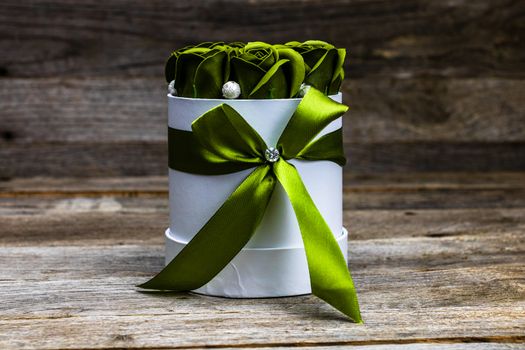 Green roses in a round luxury present box. Bouquet of flowers in a paper box isolated.