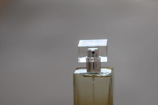 Elegant perfume bottle isolated on blurred background with copy space.