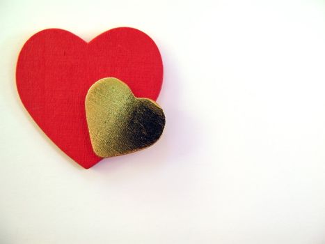Red and golden heart on white background with copy space