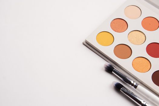 eyeshadows on isolated background and makeup brushes professional cosmetics. High quality photo