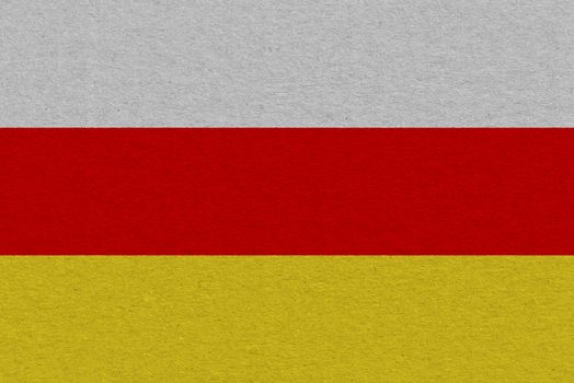 South ossetia flag painted on paper. Patriotic background. National flag of South ossetia