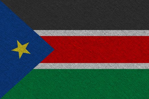 South Sudan fabric flag. Patriotic background. National flag of South Sudan