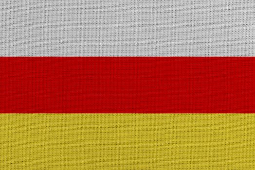 South ossetia fabric flag. Patriotic background. National flag of South ossetia