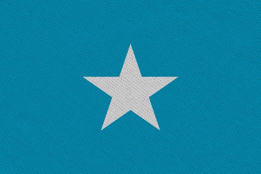Somalia fabric flag. Patriotic background. National flag of Somalia
