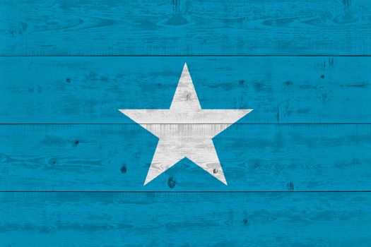 Somalia flag painted on old wood plank. Patriotic background. National flag of Somalia