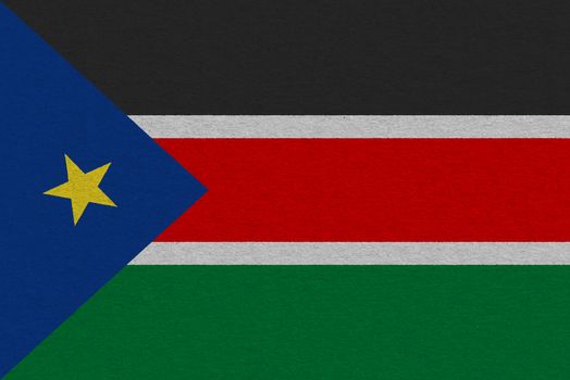 South Sudan flag painted on paper. Patriotic background. National flag of South Sudan