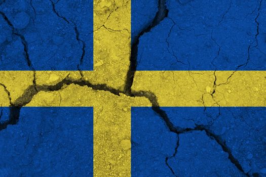 Sweden flag on the cracked earth. National flag of Sweden. Earthquake or drought concept