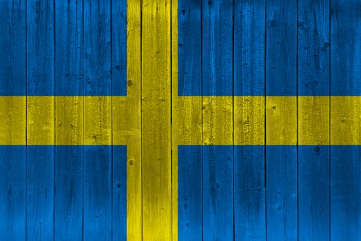 Sweden flag painted on old wood plank. Patriotic background. National flag of Sweden