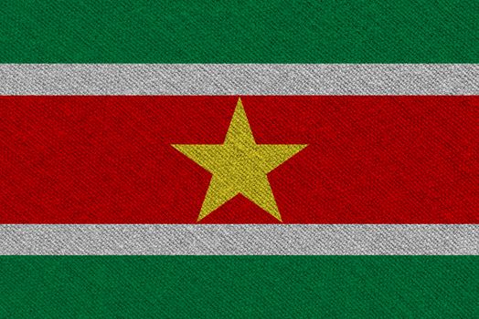 Suriname fabric flag. Patriotic background. National flag of Suriname
