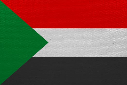 Sudan flag on canvas. Patriotic background. National flag of Sudan