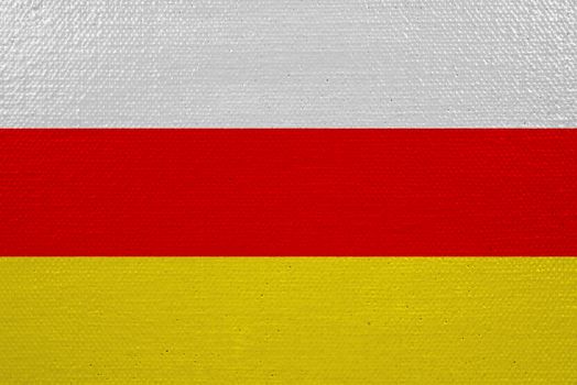 South ossetia flag on canvas. Patriotic background. National flag of South ossetia