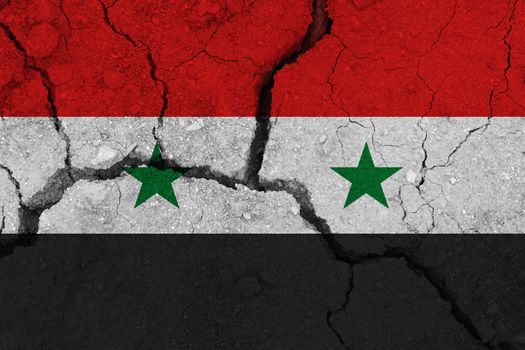 Syria flag on the cracked earth. National flag of Syria. Earthquake or drought concept