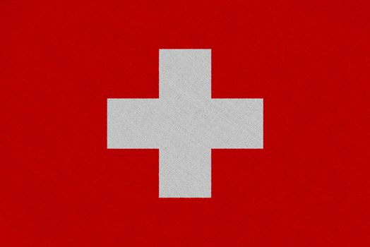 Switzerland fabric flag. Patriotic background. National flag of Switzerland