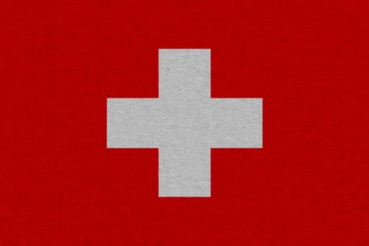 Switzerland flag painted on paper. Patriotic background. National flag of Switzerland