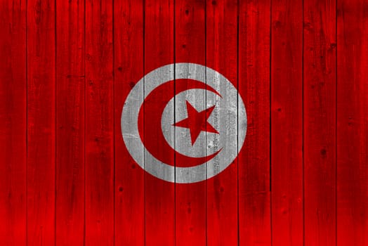 Tunisia flag painted on old wood plank. Patriotic background. National flag of Tunisia
