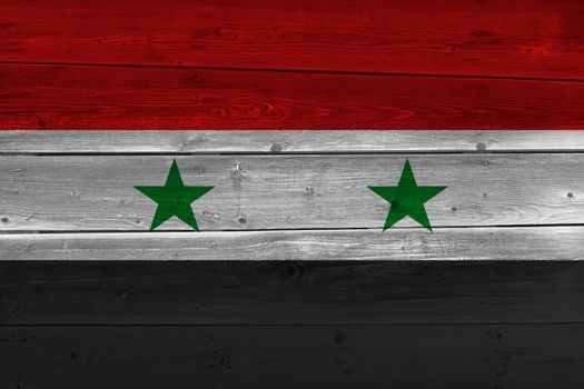 Syria flag painted on old wood plank. Patriotic background. National flag of Syria