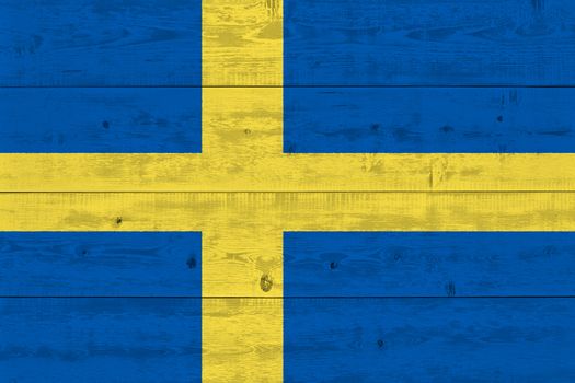 Sweden flag painted on old wood plank. Patriotic background. National flag of Sweden
