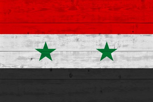 Syria flag painted on old wood plank. Patriotic background. National flag of Syria