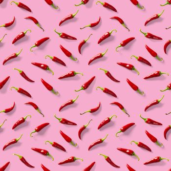 Red hot chilli seamless peppers pattern. Seamless pattern made of red chili or chilli on pink background. Minimal food pattern. Food background.