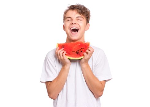 Portrait of teen boy eating ripe juicy watermelon and smiling.