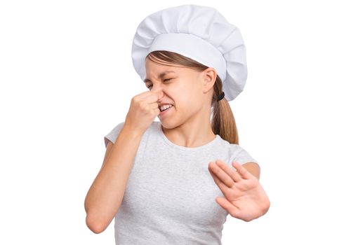 Girl wearing a chef's hat,pinches nose with fingers looks with disgust, isolated on white background.