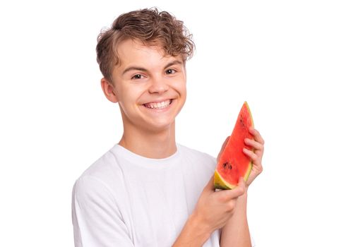 Portrait of teen boy eating ripe juicy watermelon and smiling.