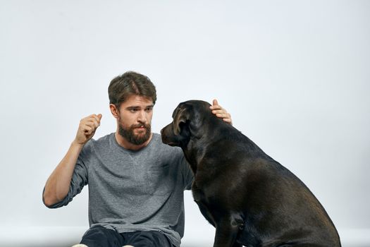 happy owner with pet black dog training model emotions. High quality photo