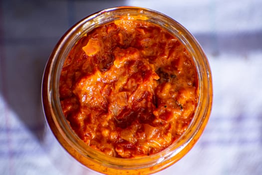 Freshly cooked ajvar in the glass jar. Shot from above