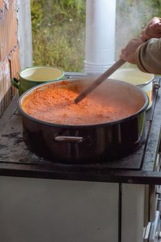 Cooking Ajvar made of tomatoes and paprika buy the old recepies