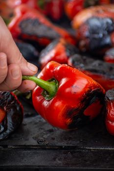 Red peppers roasting on a wood-fired stove in preparation for making ajvar, a traditional serbian dish