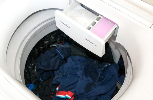 Detergent and fabric softener in the washing machine.