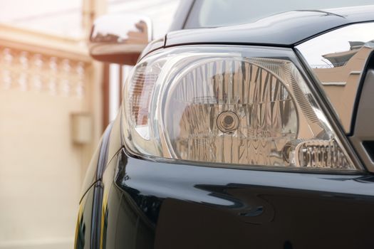 Closeup of car headlight lamp with beautiful sunlight.