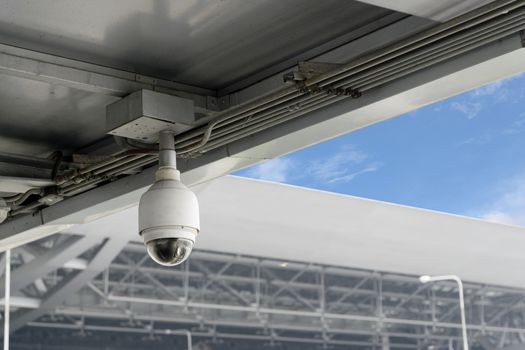 Closeup CCTV cameras on the roof with blue sky background.