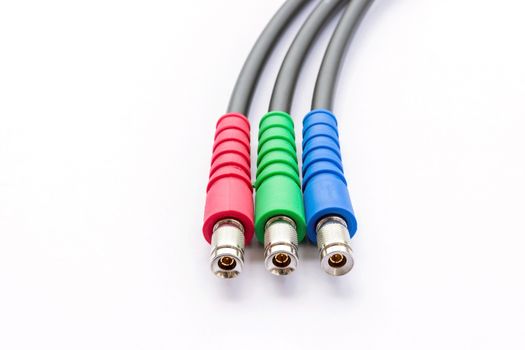 Closeup of BNC RGB color connector for video signal on white background.