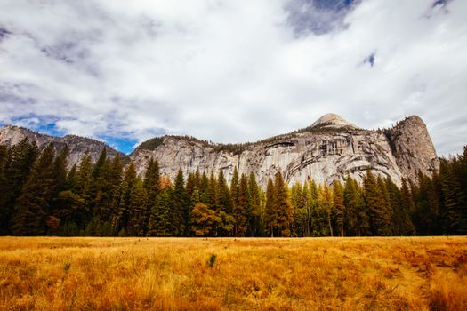 The view from within Yosemite Valley of surrounding rock faces on a stormy day in California, USA