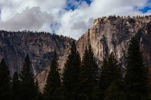 The view from within Yosemite Valley of surrounding rock faces on a stormy day in California, USA