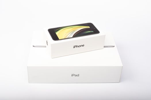 Paris, France - May 14, 2020: packaging of the new black iPhone SE 2020 and iPad from the multinational company Apple during the days of its studio release on a white background