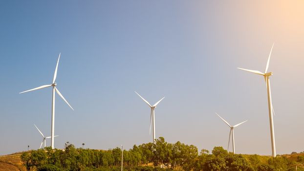 Wind turbine for electricity production on the mountains and beautiful sky.