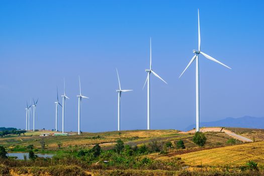 Wind turbine for electricity production on the mountains and beautiful sky.