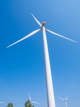 Wind turbine for electricity production on the mountains and beautiful sky.